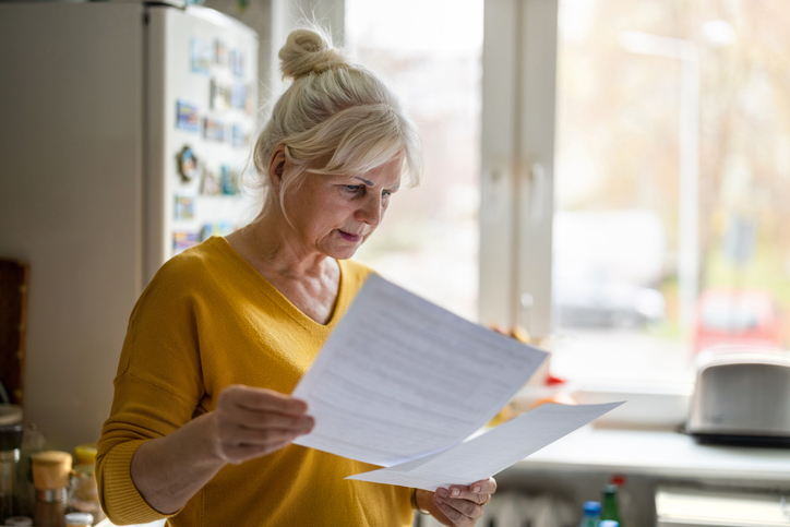 Woman reading paperwork after receiving an inheritance