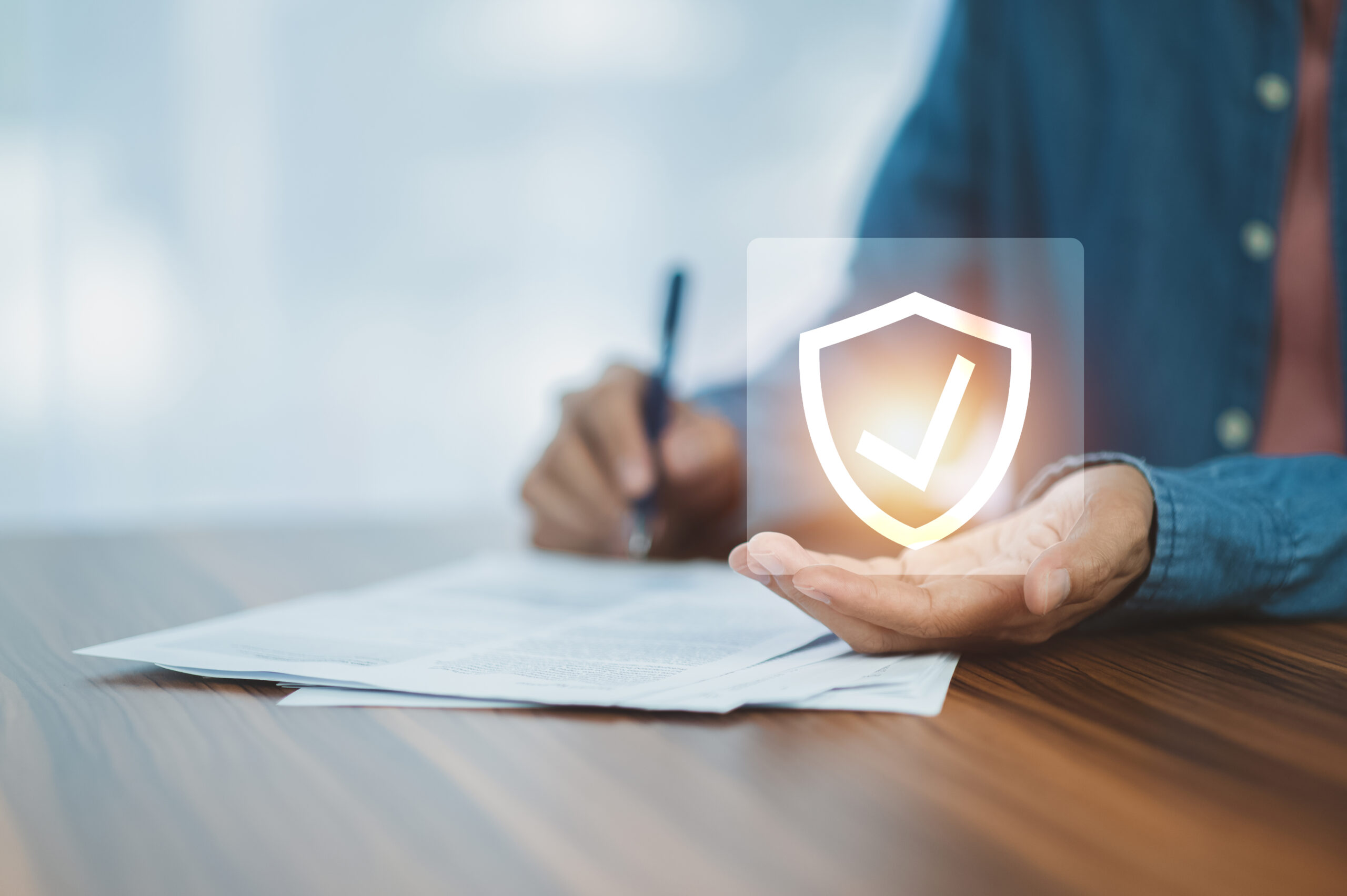 Man signing document for life insurance and asset protection